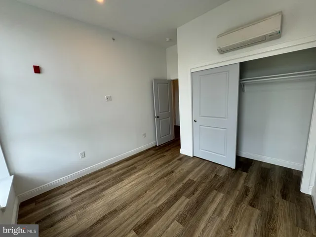 an empty room with wooden floor