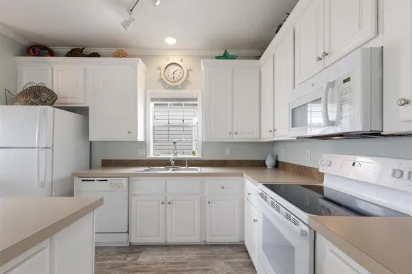 a kitchen with granite countertop cabinets stainless steel appliances and a sink