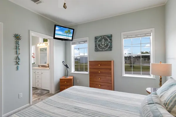 a bedroom with a bed dresser and a window