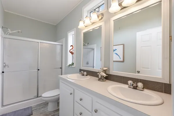 a bathroom with a sink a toilet and a large mirror