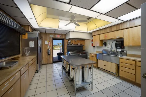 a kitchen with stainless steel appliances granite countertop a sink and cabinets