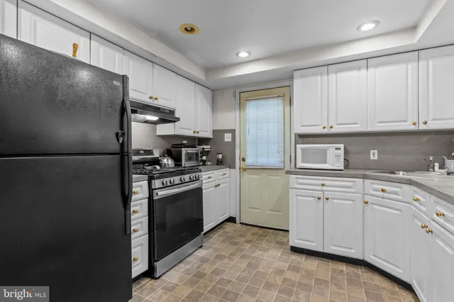 a kitchen with cabinets stainless steel appliances and a counter top