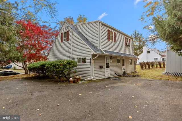 a view of a house with a yard and a garage