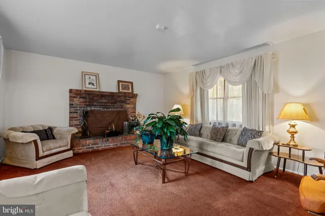 a living room with furniture a window and a fireplace