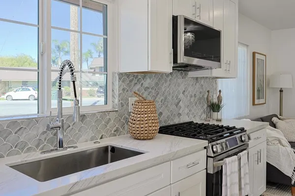 a kitchen that has a sink and a stove
