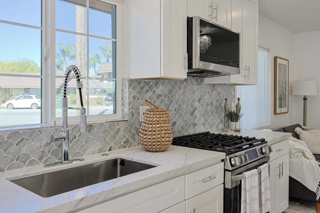 a kitchen that has a sink and a stove