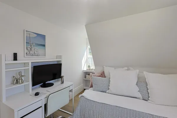 a bedroom with a bed and a flat screen tv