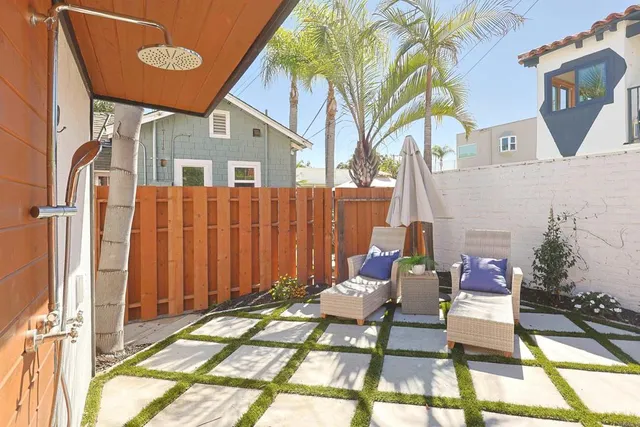 a view of a patio with a table and chairs and potted plants