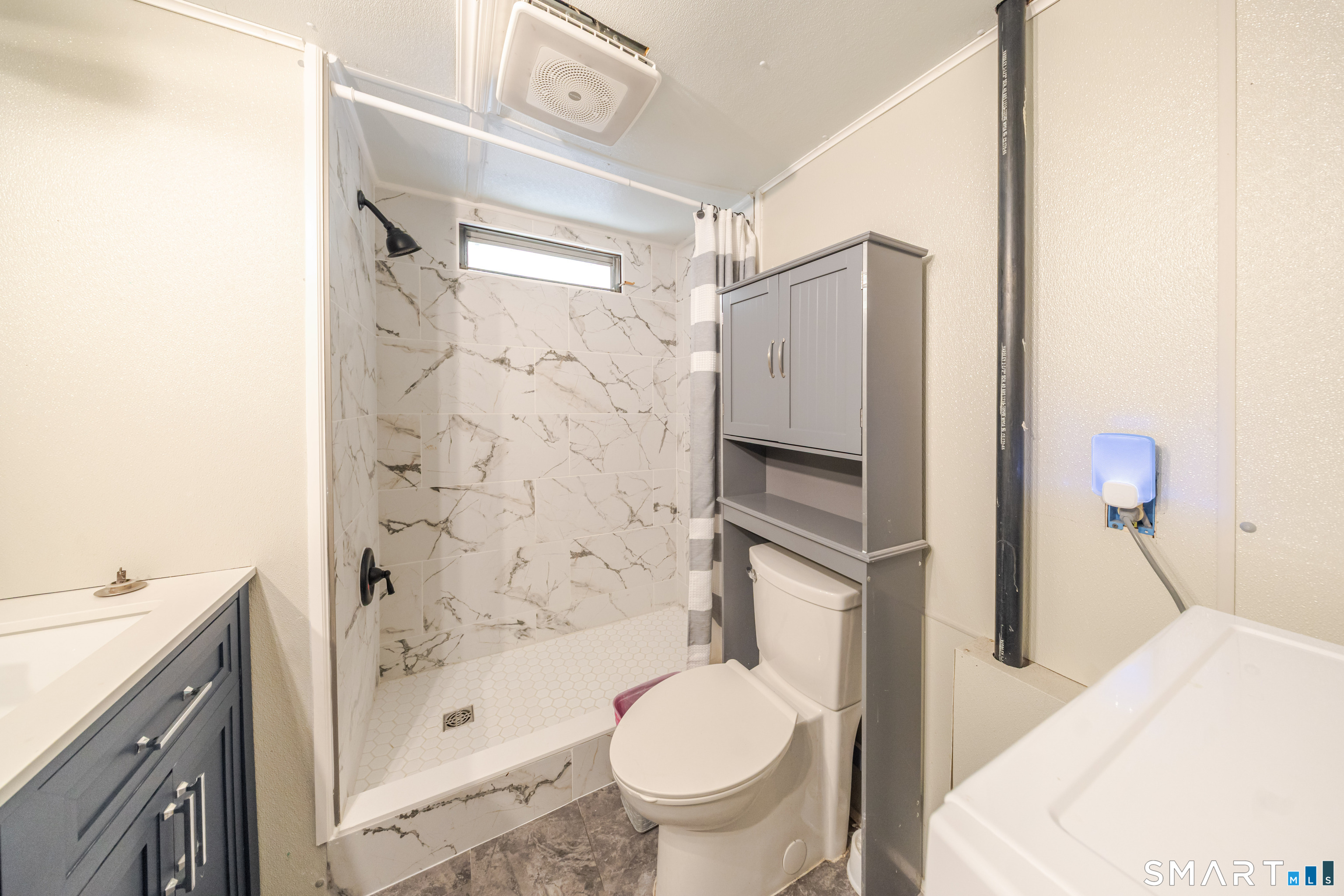 93 Shawnee Road East Hartford, CT 06118 - Photo 17 of 37 a bathroom with a granite countertop sink toilet and shower
