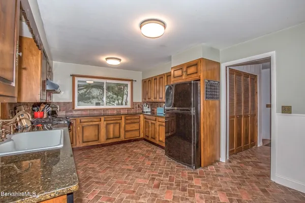 a kitchen with refrigerator cabinets and furniture