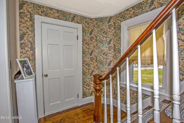 a view of a dining room with furniture and a window