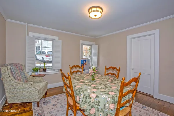 a dining room with furniture and wooden floor