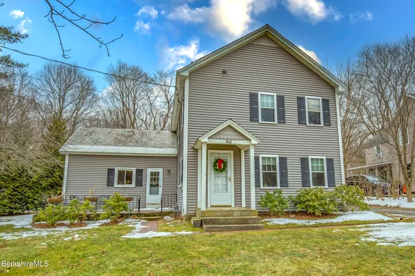 a front view of a house with a yard