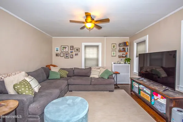 a living room with furniture and stairs