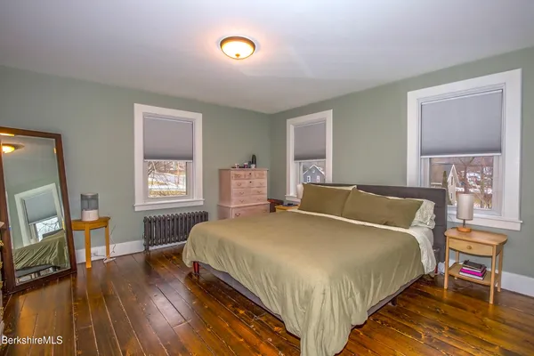 a bedroom with a bed and a mirror