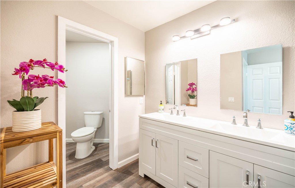 102 Vía Contento Rancho Santa Margarita, CA 92688 - Photo 19 of 40 a bathroom with a sink vanity granite and toilet