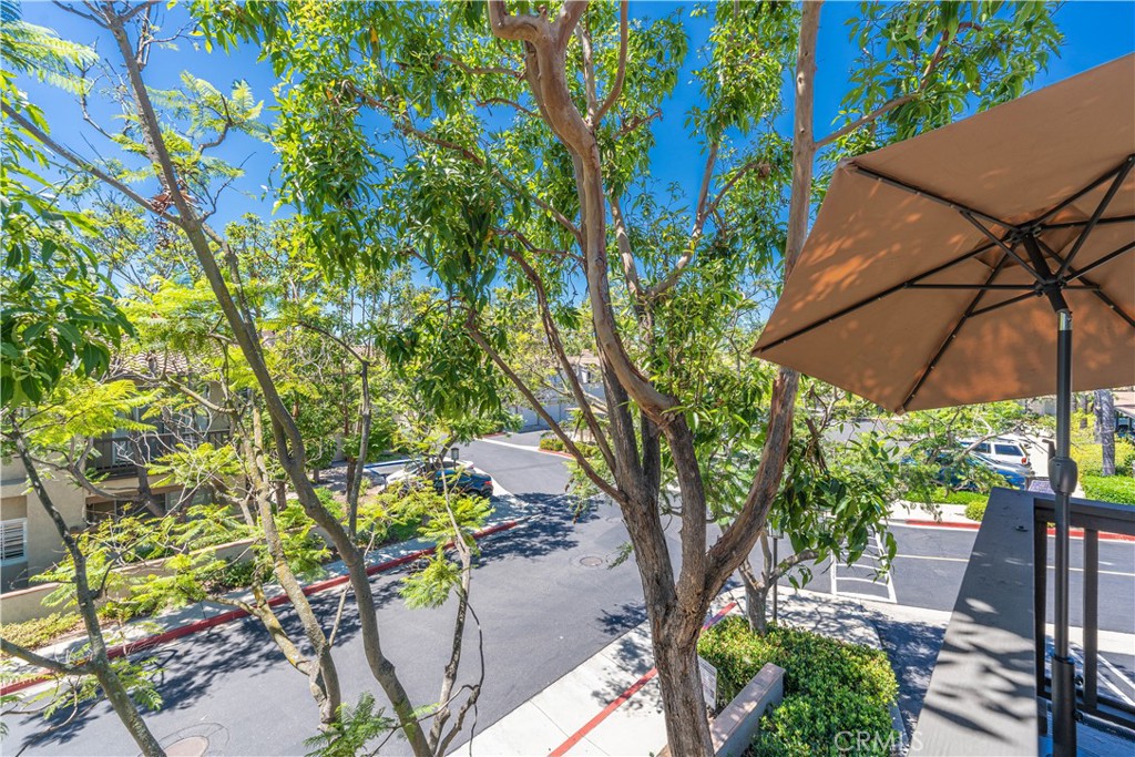 102 Vía Contento Rancho Santa Margarita, CA 92688 - Photo 27 of 40 a backyard of a house with table and chairs under an umbrella