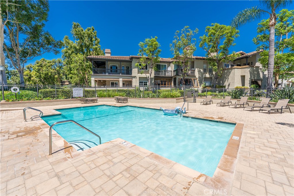 102 Vía Contento Rancho Santa Margarita, CA 92688 - Photo 31 of 40 a view of a house with a swimming pool and sitting area
