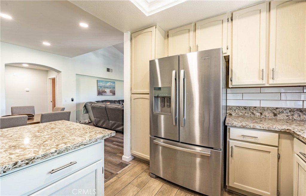 102 Vía Contento Rancho Santa Margarita, CA 92688 - Photo 4 of 40 a kitchen with kitchen island granite countertop appliances cabinets and a counter space