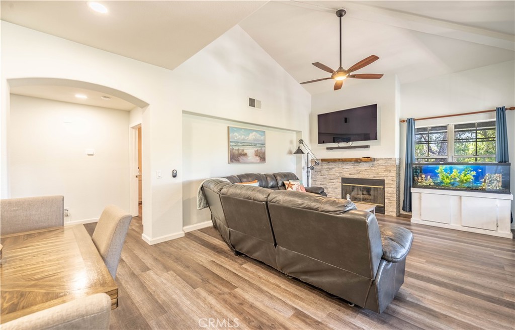102 Vía Contento Rancho Santa Margarita, CA 92688 - Photo 8 of 40 a living room with furniture a flat screen tv and a fireplace