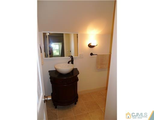 541 Georges Road Dayton, NJ 08810 - Photo 14 of 24 a bathroom with a sink and mirror