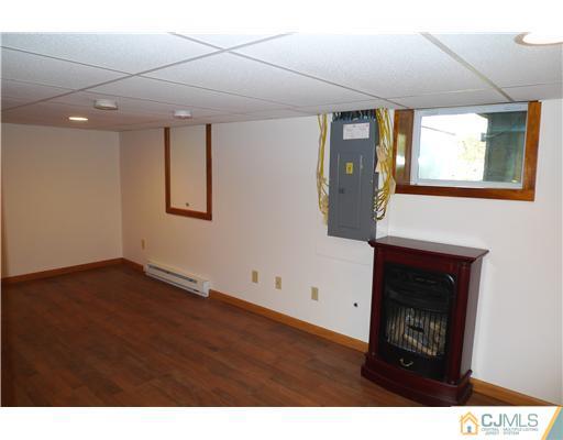 541 Georges Road Dayton, NJ 08810 - Photo 18 of 24 a view of an empty room with wooden floor and a window