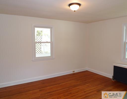 541 Georges Road Dayton, NJ 08810 - Photo 8 of 24 an empty room with wooden floor and windows