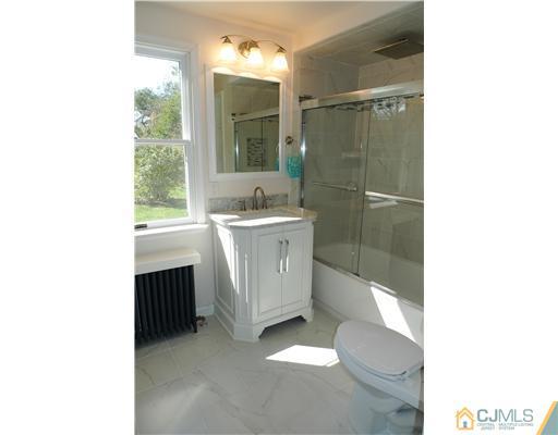 541 Georges Road Dayton, NJ 08810 - Photo 10 of 24 a bathroom with a sink a toilet and shower
