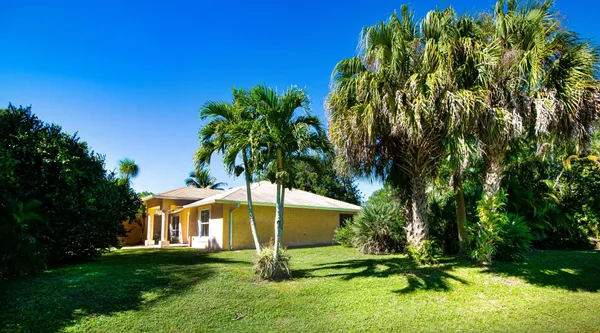 a view of a backyard with swimming pool