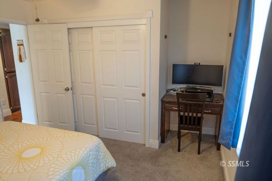 644 Beth Lane Ridgecrest, CA 93555 - Photo 16 of 31 a bedroom with a bed and a chair