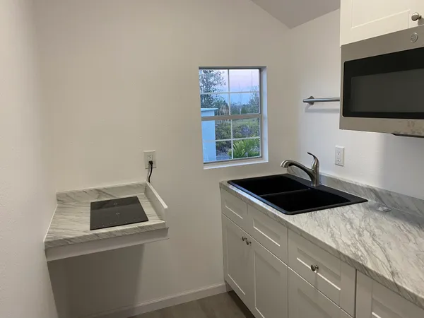 a kitchen that has a sink and a stove