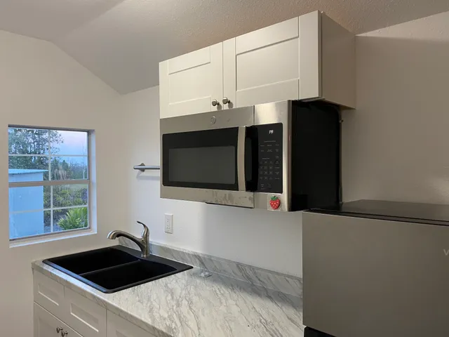 a kitchen with a sink and a microwave