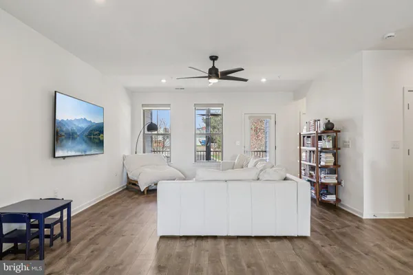a living room with furniture and wooden floor