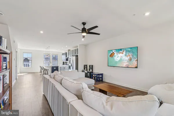 a living room with furniture and a chandelier