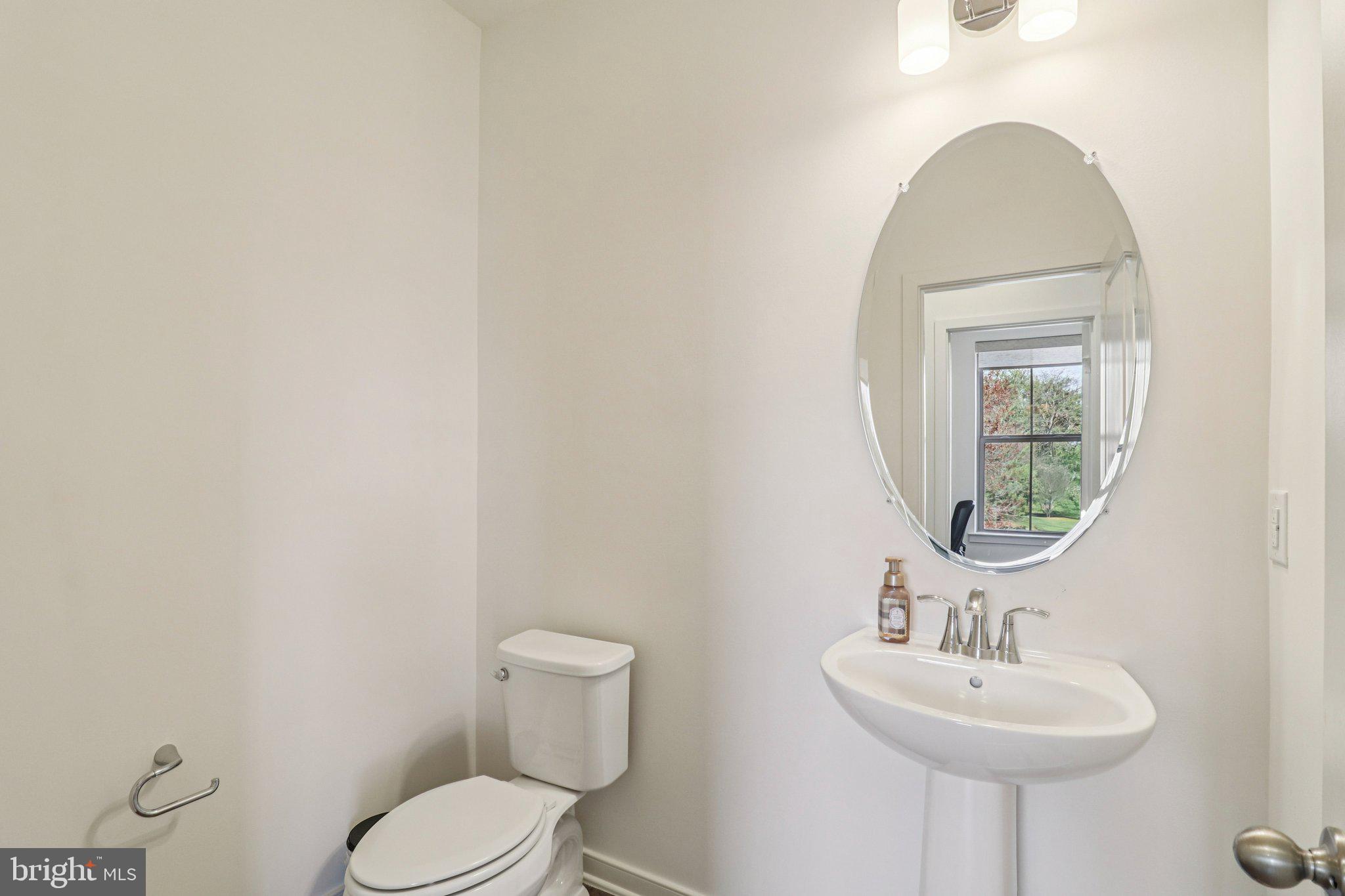 45916 Swallow Terrace Sterling, VA 20165 - Photo 19 of 41 a bathroom with a toilet sink and mirror
