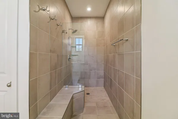 a bathroom with a bathtub and shower