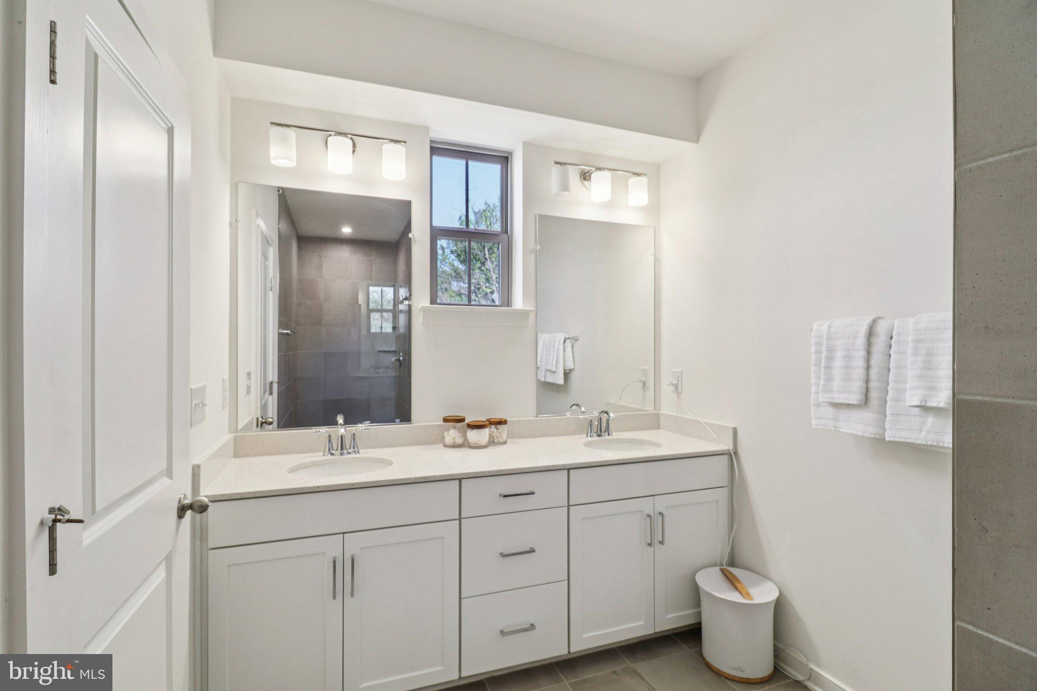 45916 Swallow Terrace Sterling, VA 20165 - Photo 27 of 41 a bathroom with a double vanity sink and a mirror