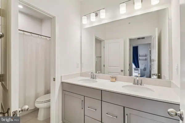 a bathroom with a double vanity sink and a mirror