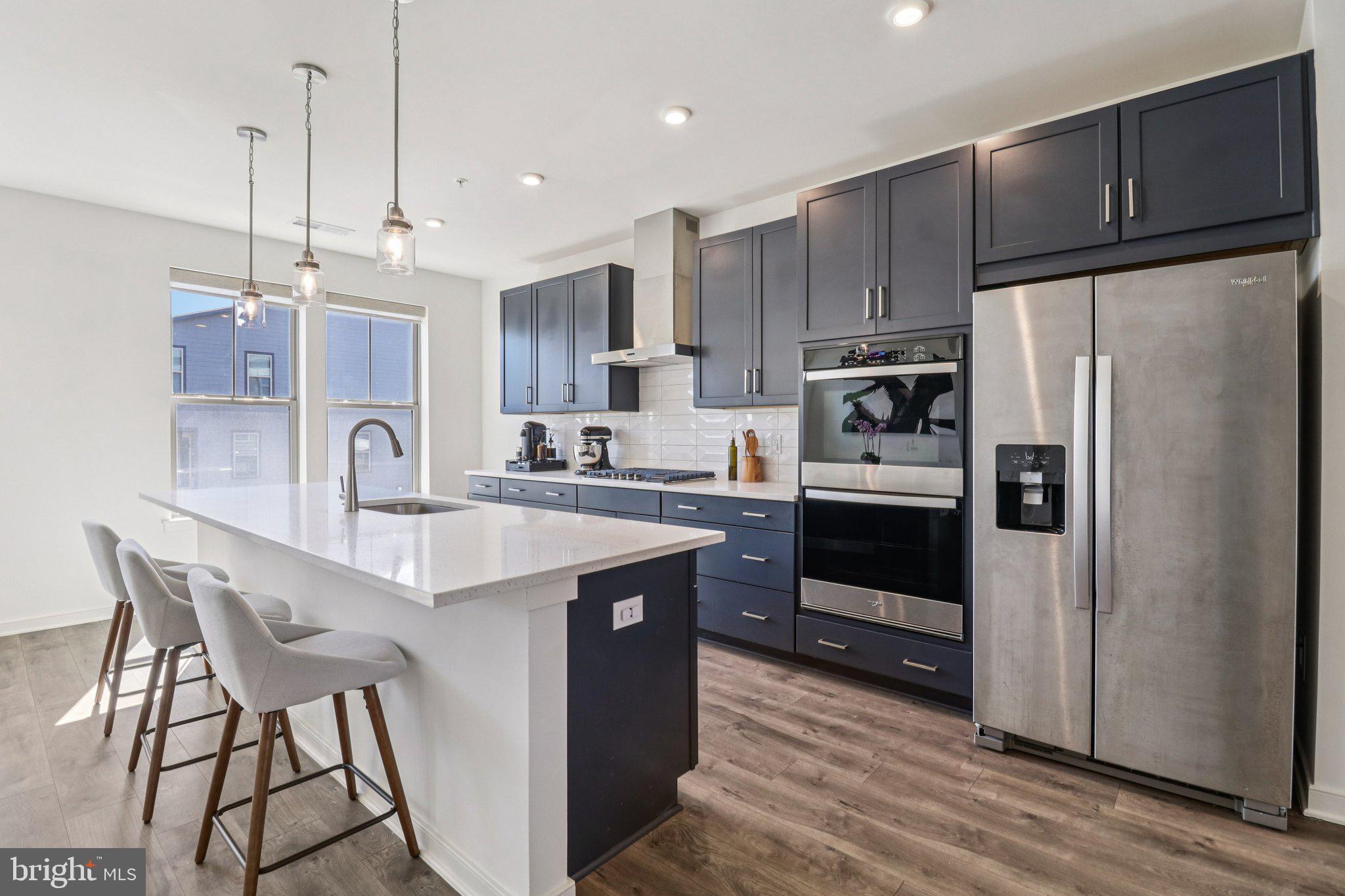 45916 Swallow Terrace Sterling, VA 20165 - Photo 3 of 41 a kitchen with kitchen island a counter space a sink appliances and cabinets