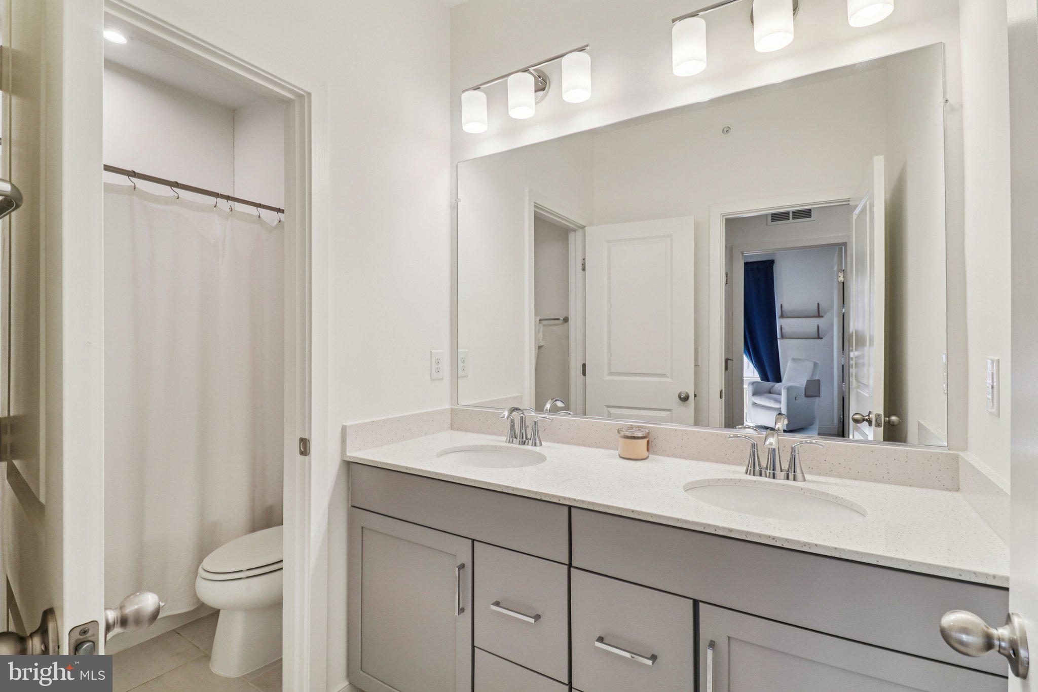 45916 Swallow Terrace Sterling, VA 20165 - Photo 31 of 41 a bathroom with a double vanity sink toilet and a mirror