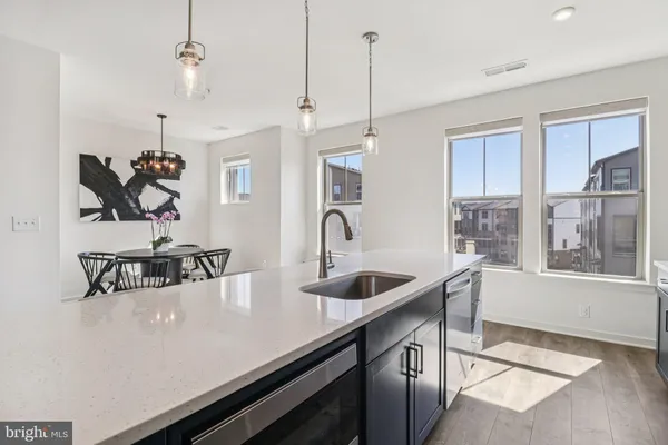 a view of a kitchen with kitchen island a sink and a stove