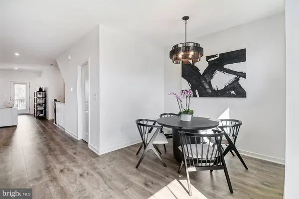 a view of a dining room with furniture wooden floor and chandelier