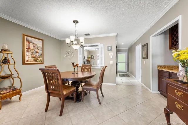a view of a dining room with furniture and chandelier