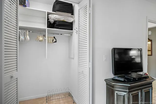 a room with wooden floor and white wall