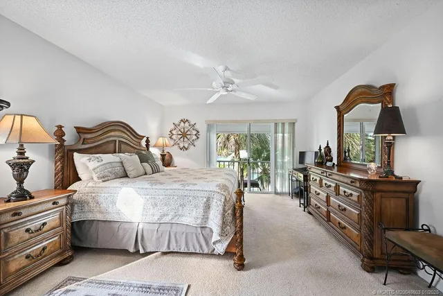 a spacious bedroom with a bed a couch and dresser