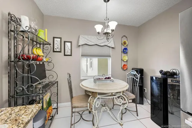 a view of a dining room with furniture and chandelier