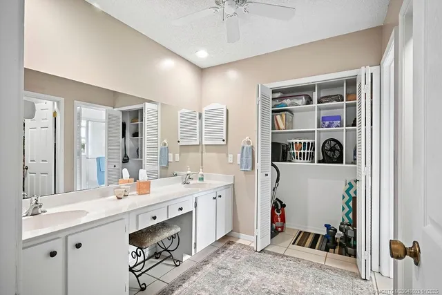 a en suite bathroom with a double vanity sink mirror and