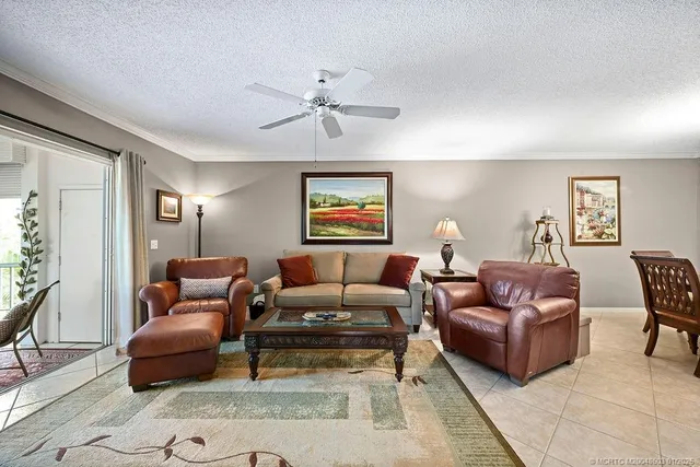 a living room with furniture a rug a window and a lamp
