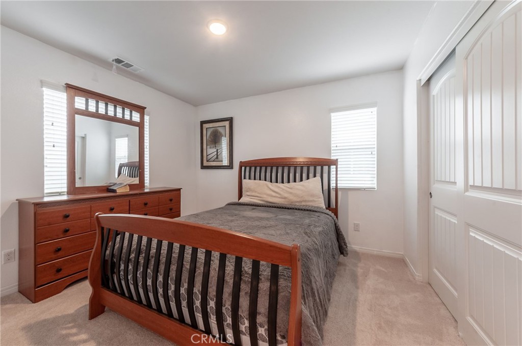 27283 Chase Road Menifee, CA 92584 - Photo 11 of 16 a bedroom with a bed and wooden floor