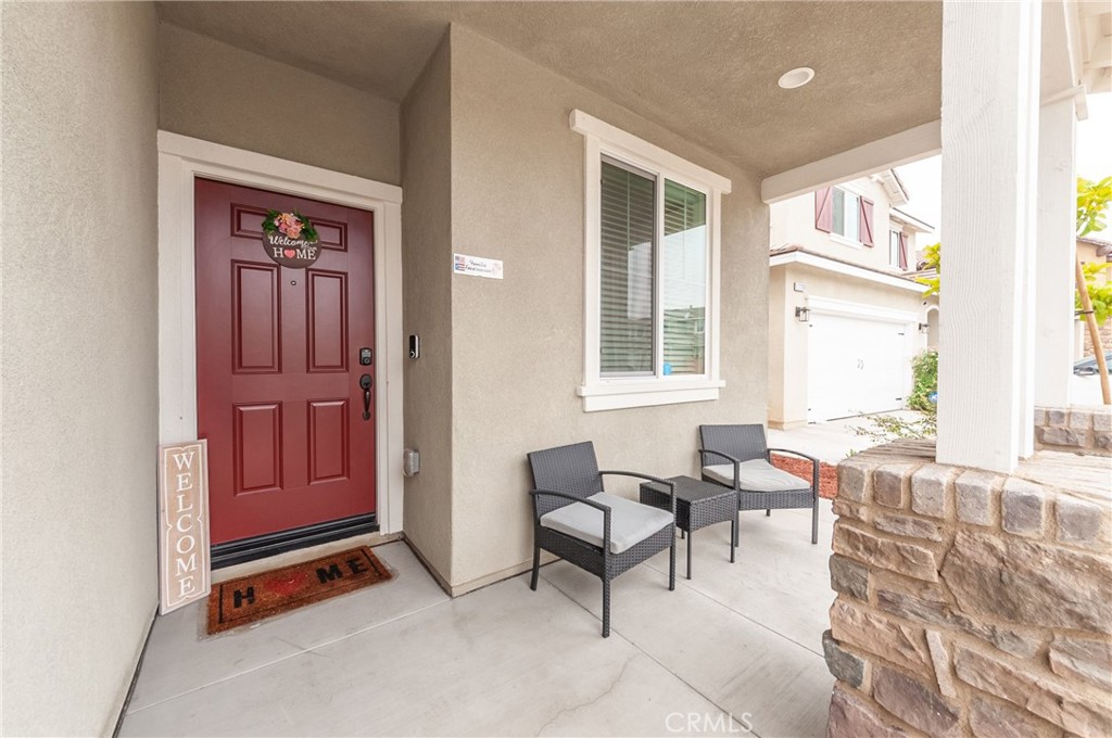 27283 Chase Road Menifee, CA 92584 - Photo 2 of 16 a living room with furniture a window and a flat screen tv